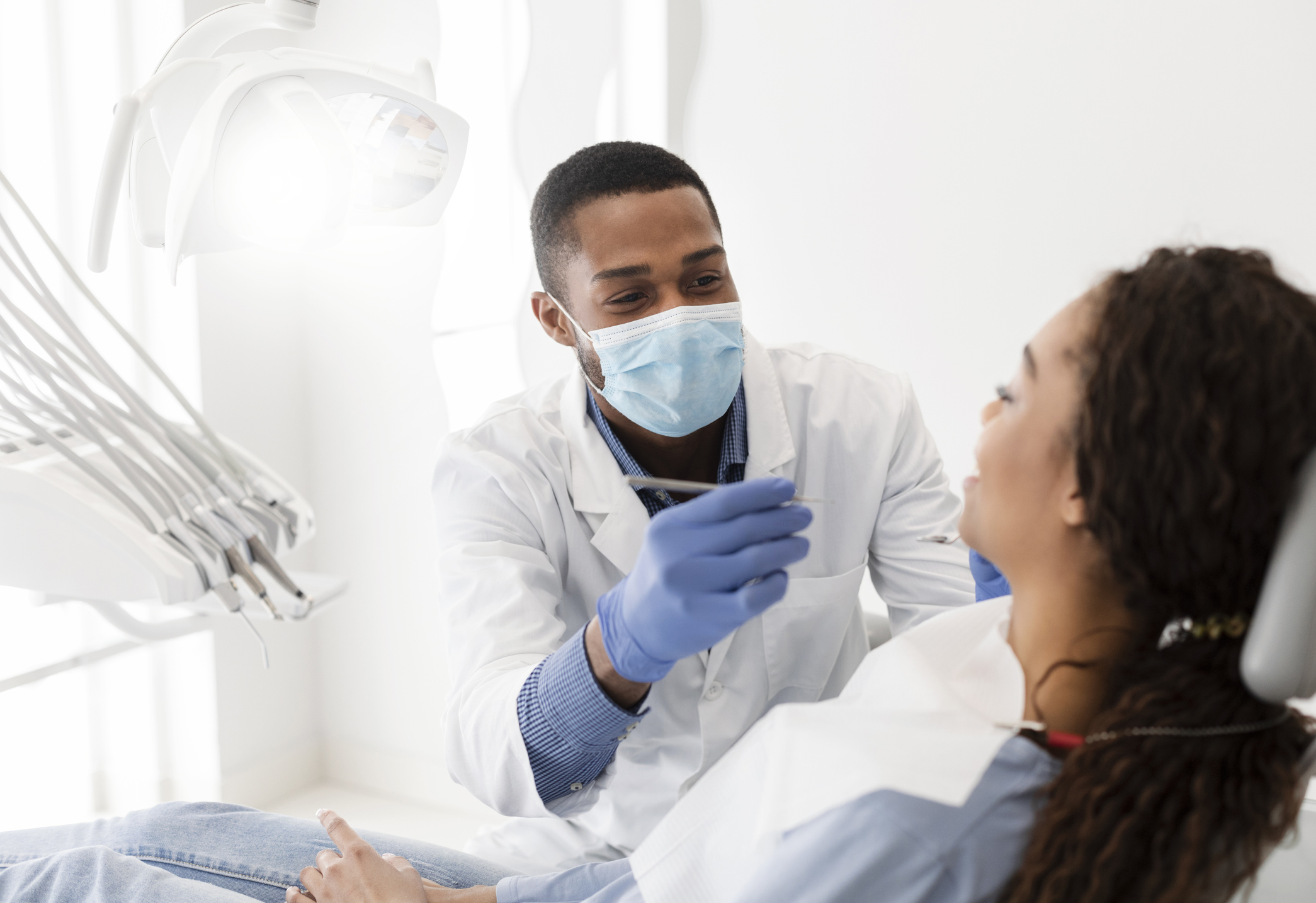 dentist making treatment in modern clinic