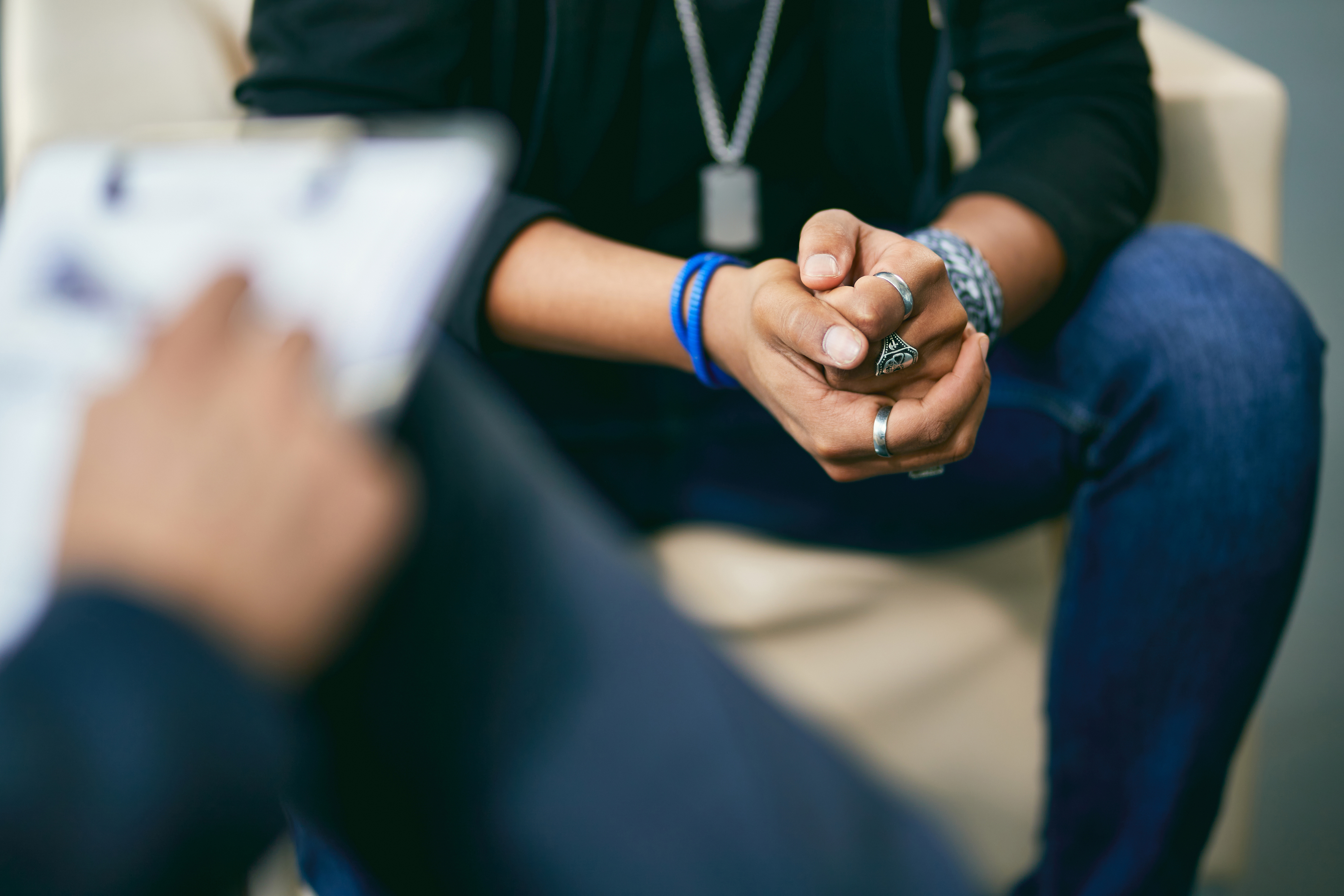 Close-up of teenage boy having a session with mental health professional 